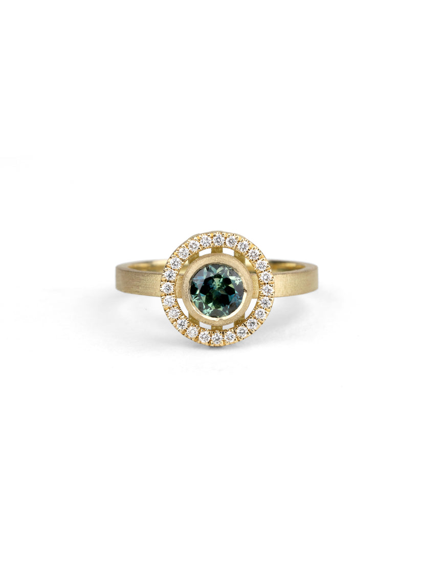 Blue green sapphire ring with a diamond halo, 18ct yellow gold textured finish.