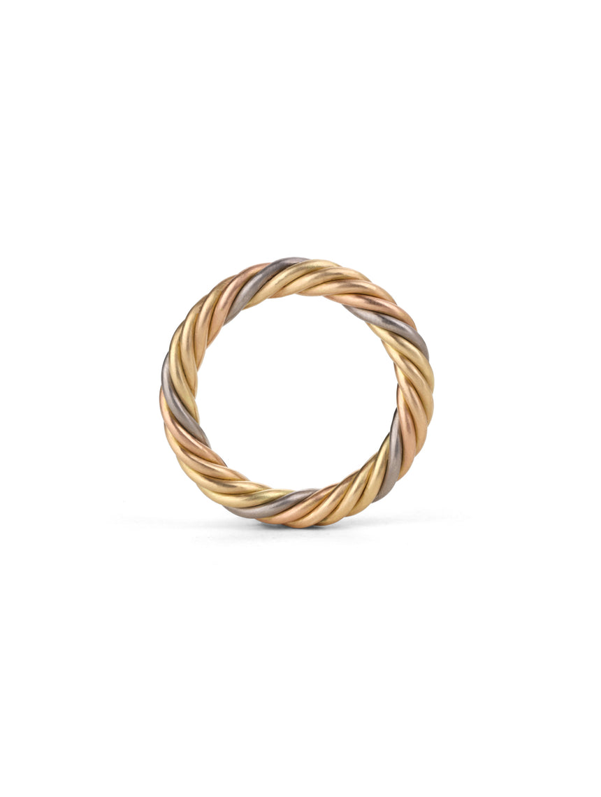 Rope style band ring with five different colour gold alloys twisted together. Side view.