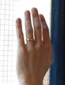 Flat wedding band. 18ct yellow gold, satin finish. On hand.