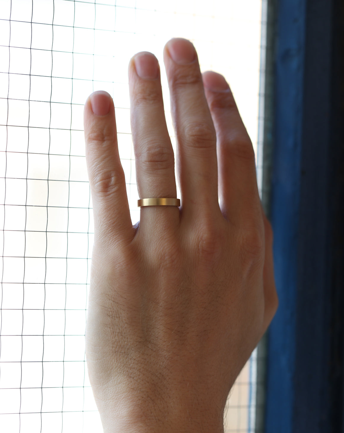 Flat wedding band. 18ct yellow gold, satin finish. On hand.