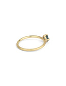 Solitaire ring in textured 18ct yellow gold with a round teal sapphire, side view