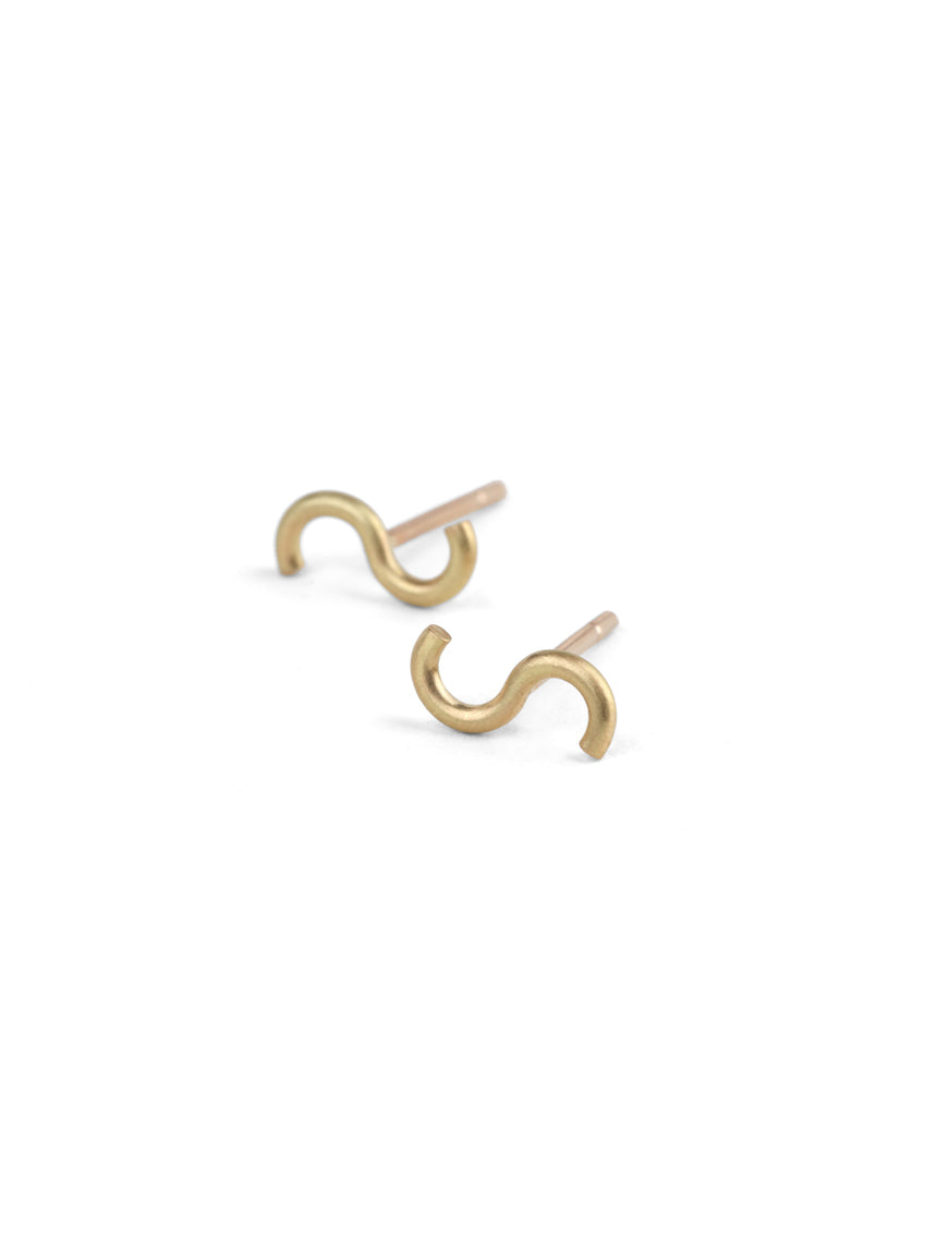 Stud earrings in an S shape. 18ct yellow gold, satin finish.